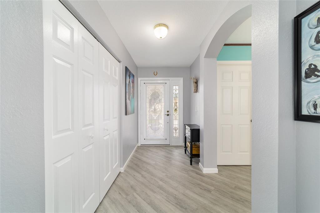 8608 Southeast 141st Street Road Summerfield, FL 34491 - Photo 5 of 82 a view of a hallway with wooden floor and a bathroom