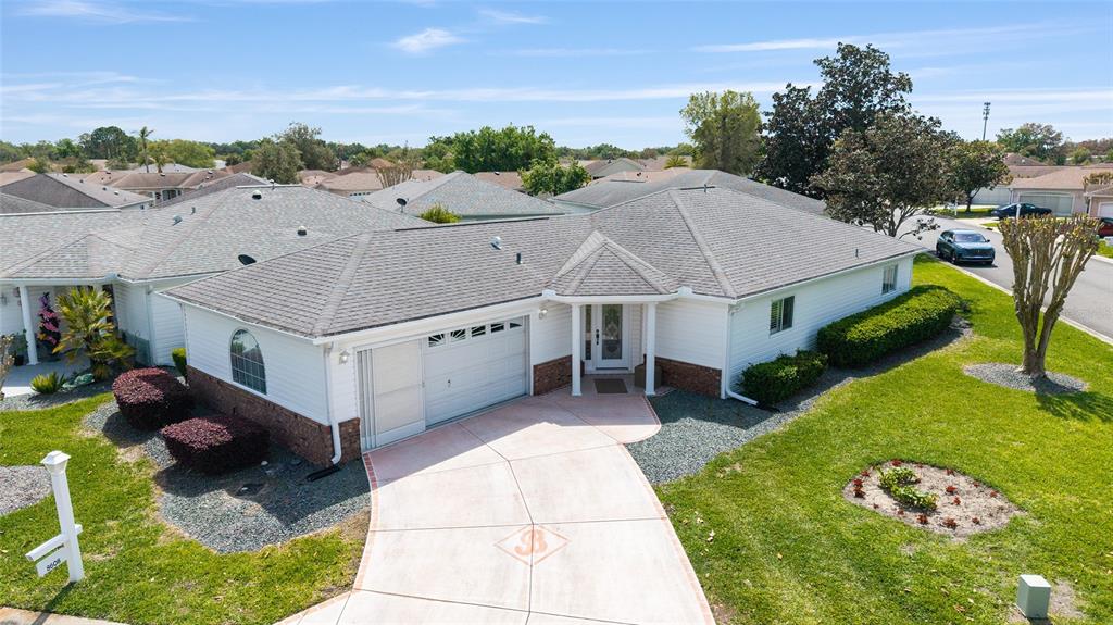 8608 Southeast 141st Street Road Summerfield, FL 34491 - Photo 51 of 82 a aerial view of a house with swimming pool and a yard