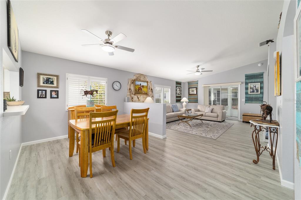 8608 Southeast 141st Street Road Summerfield, FL 34491 - Photo 6 of 82 a living room with furniture dining table and wooden floor