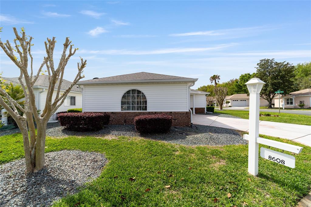 8608 Southeast 141st Street Road Summerfield, FL 34491 - Photo 62 of 82 a front view of a house with garden