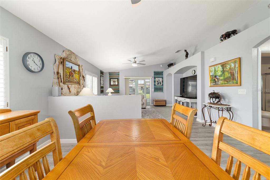 8608 Southeast 141st Street Road Summerfield, FL 34491 - Photo 7 of 82 a living room with furniture a flat screen tv and floor to ceiling window