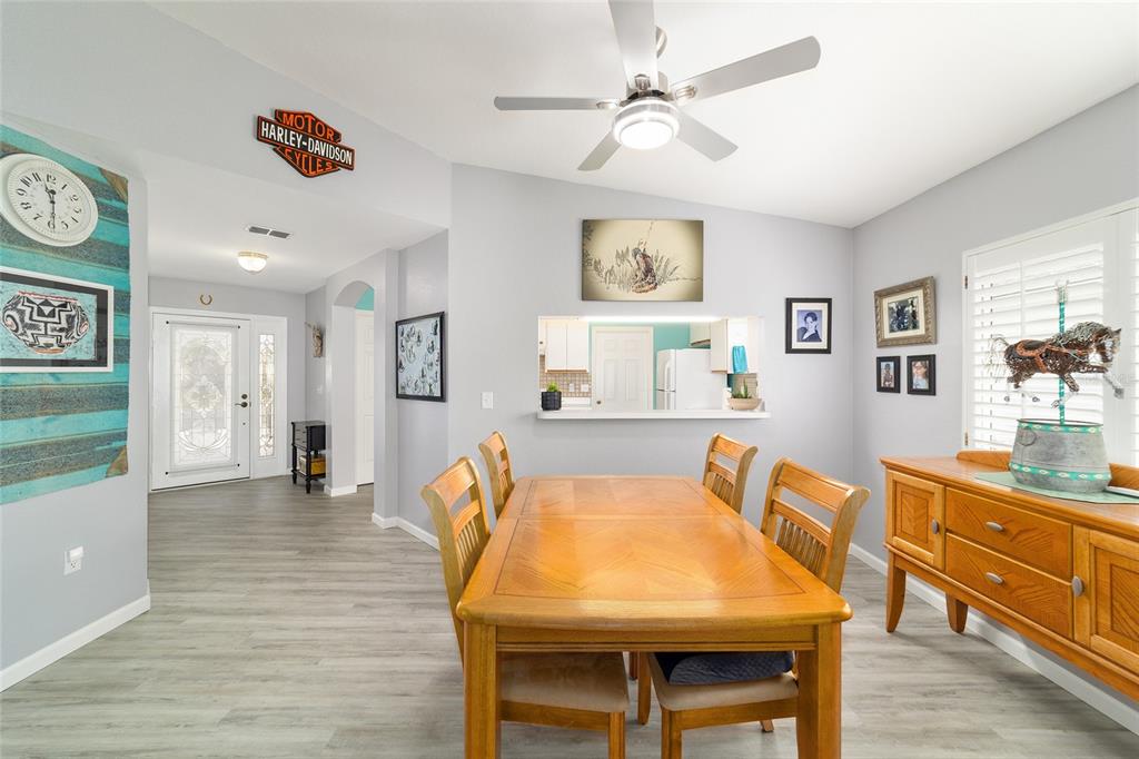 8608 Southeast 141st Street Road Summerfield, FL 34491 - Photo 10 of 82 a view of a dining room with furniture and a chandelier
