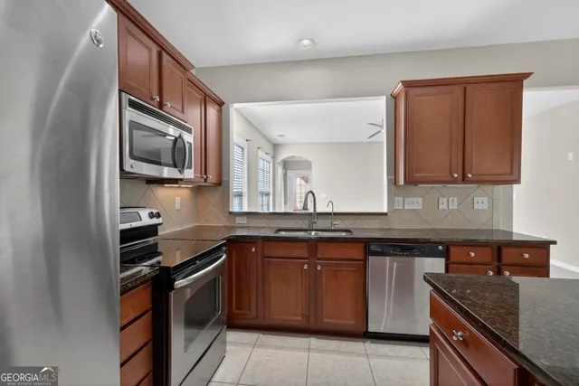a kitchen with a sink stove and microwave
