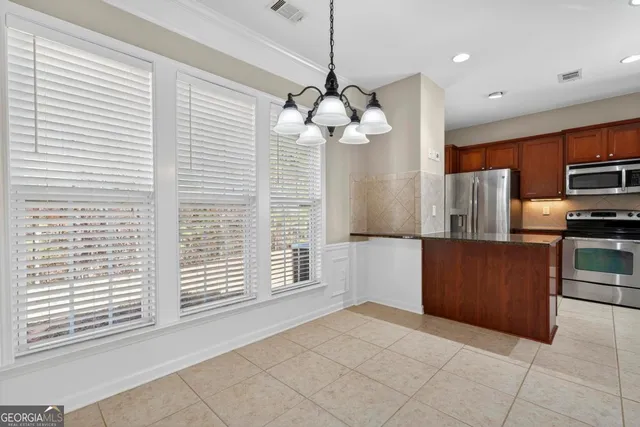 a open kitchen with a refrigerator a oven and a sink