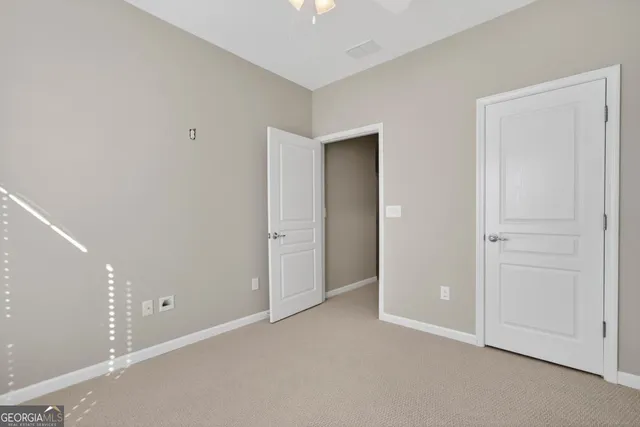 an empty room with closet area