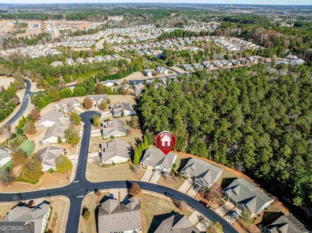 an aerial view of residential houses with outdoor space and parking