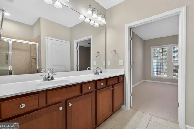 a bathroom with a double vanity sink and a mirror