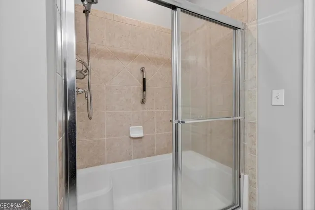 a bathroom with a glass shower door