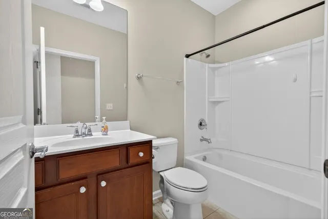a bathroom with a sink toilet tub and shower