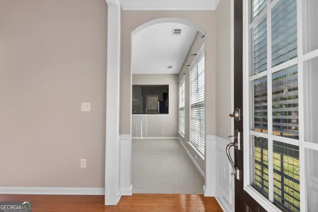 a view of a hallway with a glass door and a window
