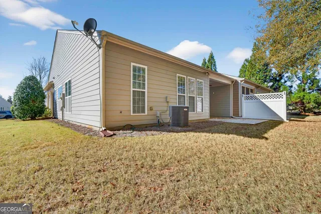 a front view of house with yard and trees around