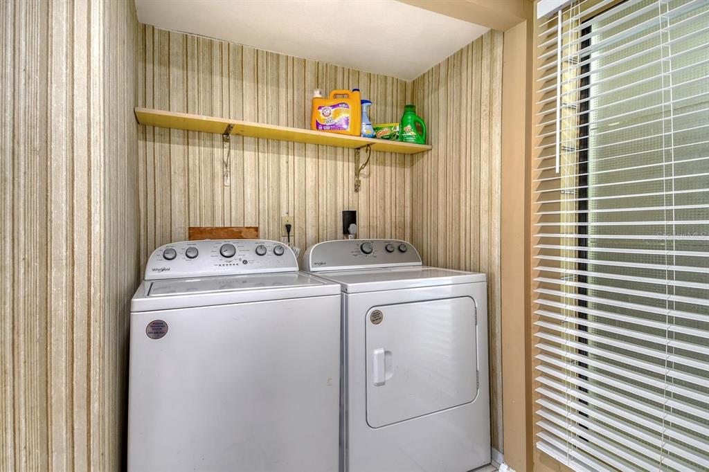 6157 Midnight Pass Road, Unit E63 Sarasota, FL 34242 - Photo 29 of 61 a utility room with dryer and washer