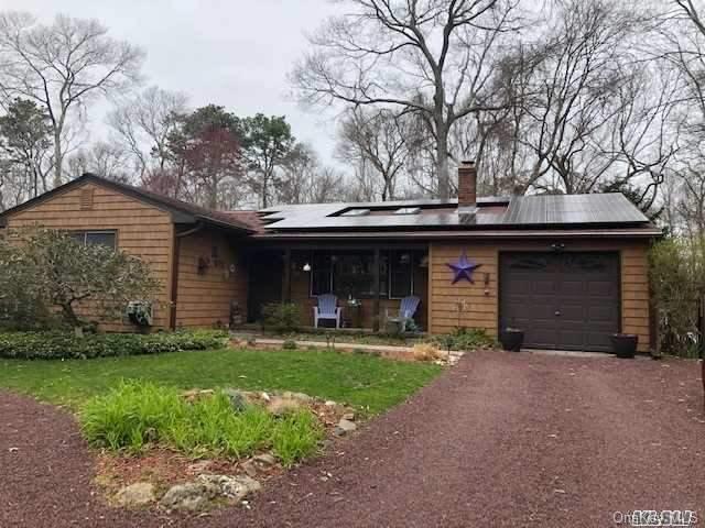 6 Shore Road Hampton Bays, NY 11946 - Photo 1 of 1 a front view of a house with a yard and garage