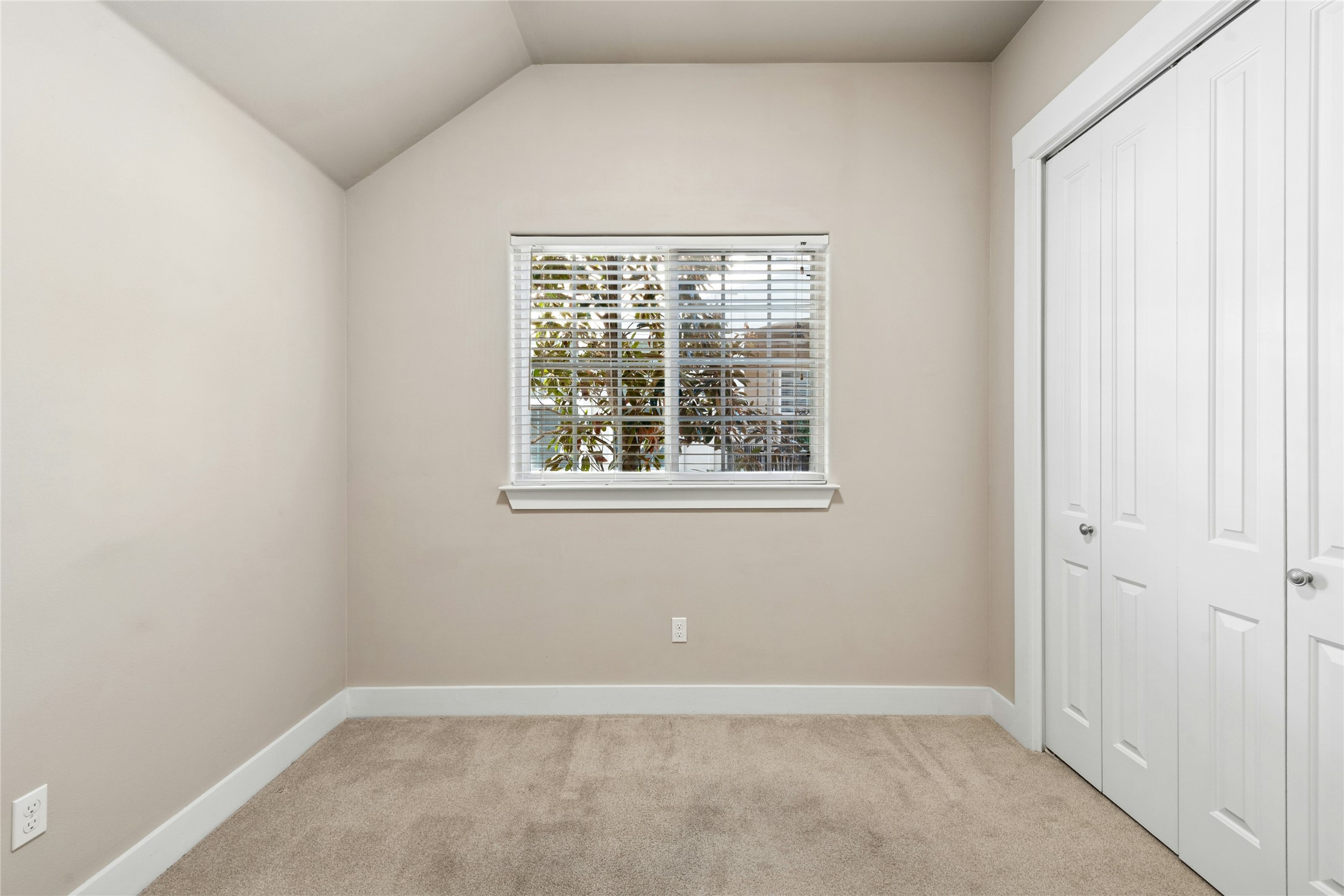 4301 Mansfield Dam Road, Unit 2101 Austin, TX 78734 - Photo 11 of 17 Unfurnished bedroom with a closet, light colored carpet, and lofted ceiling