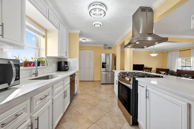 a kitchen with a sink stove and cabinets