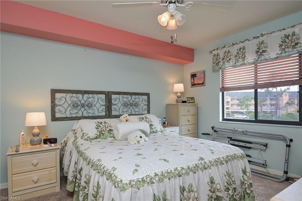 4121 Lorene Drive, Unit 207 Estero, FL 33928 - Photo 12 of 34 a bedroom with a bed and a chandelier