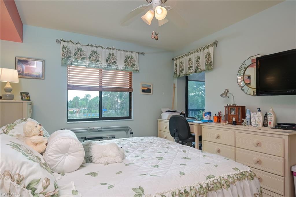 4121 Lorene Drive, Unit 207 Estero, FL 33928 - Photo 13 of 34 a bedroom with a large bed and a flat tv screen on dresser