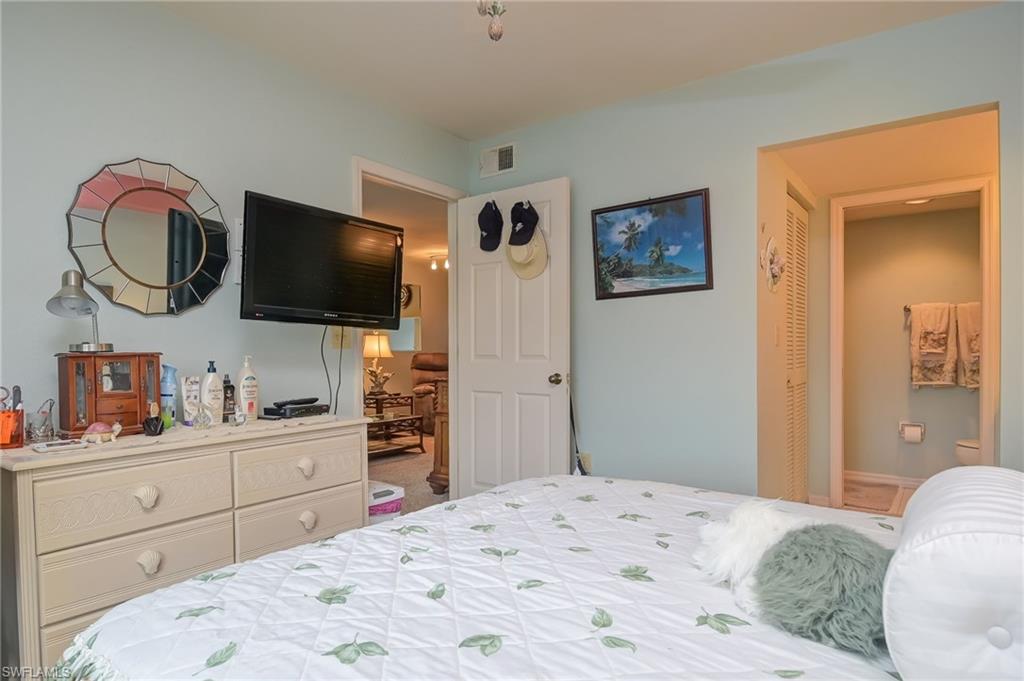 4121 Lorene Drive, Unit 207 Estero, FL 33928 - Photo 14 of 34 a bedroom with a bed and a flat screen tv