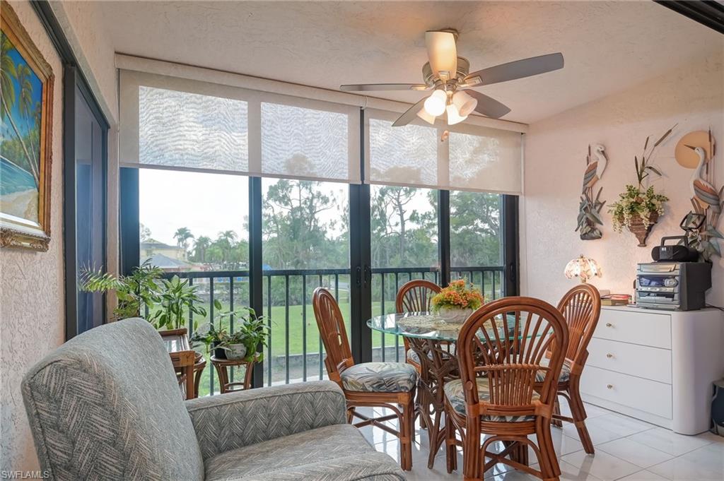 4121 Lorene Drive, Unit 207 Estero, FL 33928 - Photo 21 of 34 a dining room with furniture a flat screen tv and a large window