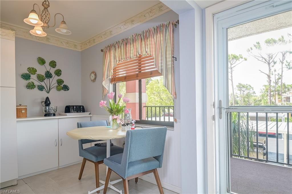 4121 Lorene Drive, Unit 207 Estero, FL 33928 - Photo 3 of 34 a dining room with furniture a large window and wooden floor