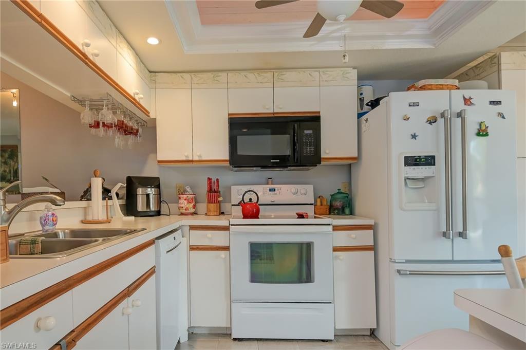 4121 Lorene Drive, Unit 207 Estero, FL 33928 - Photo 4 of 34 a kitchen with stainless steel appliances a stove microwave and refrigerator