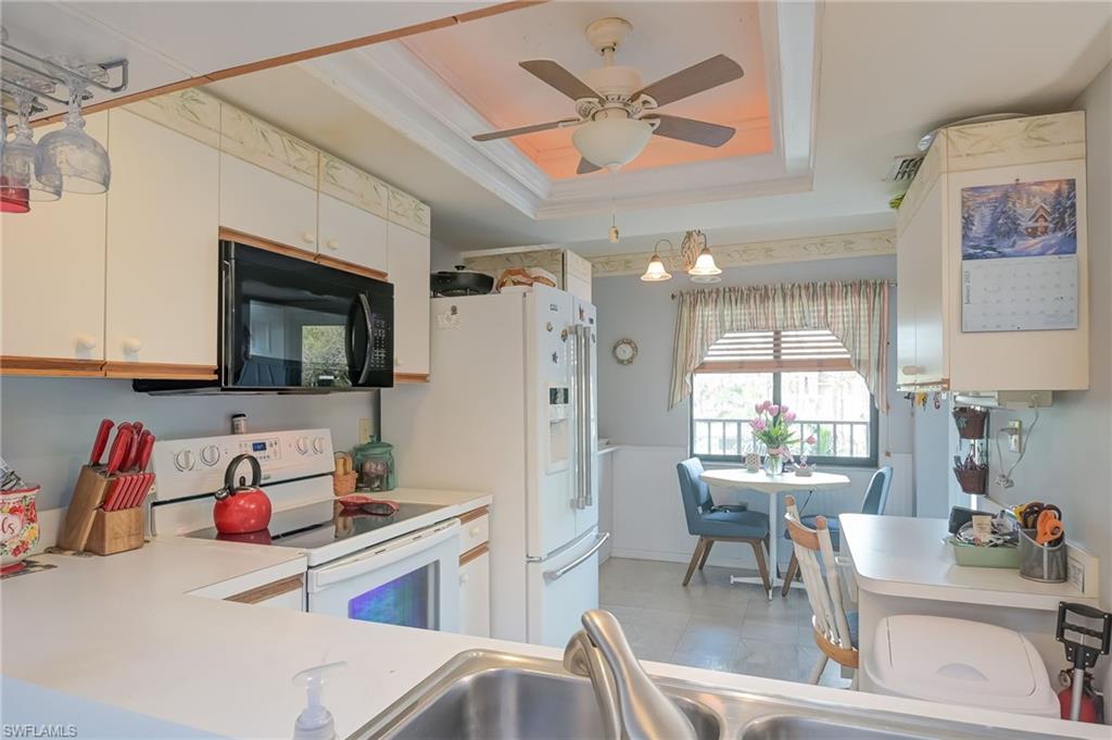 4121 Lorene Drive, Unit 207 Estero, FL 33928 - Photo 5 of 34 a kitchen with a sink appliances and cabinets