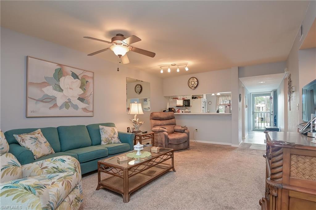 4121 Lorene Drive, Unit 207 Estero, FL 33928 - Photo 10 of 34 a living room with furniture and a chandelier