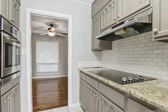 a kitchen with a sink stove and cabinets