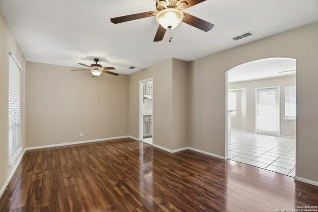 a view of an empty room with wooden floor