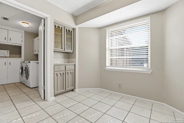 a view of a kitchen with white cabinets