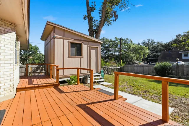 a view of balcony with wooden floor and iron fence