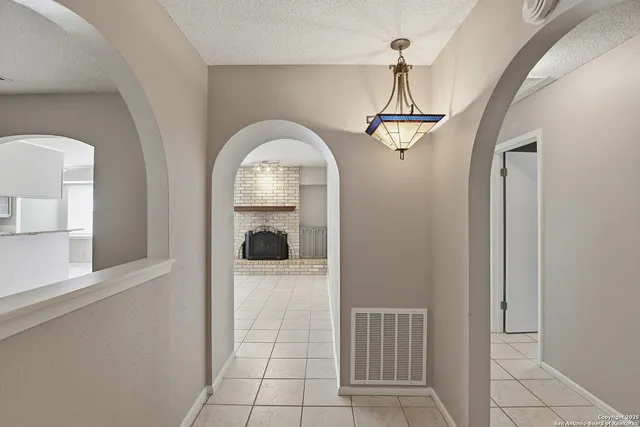 a view of a livingroom with wooden floor and a chandelier