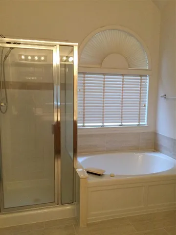 a bathroom with a bathtub and a shower