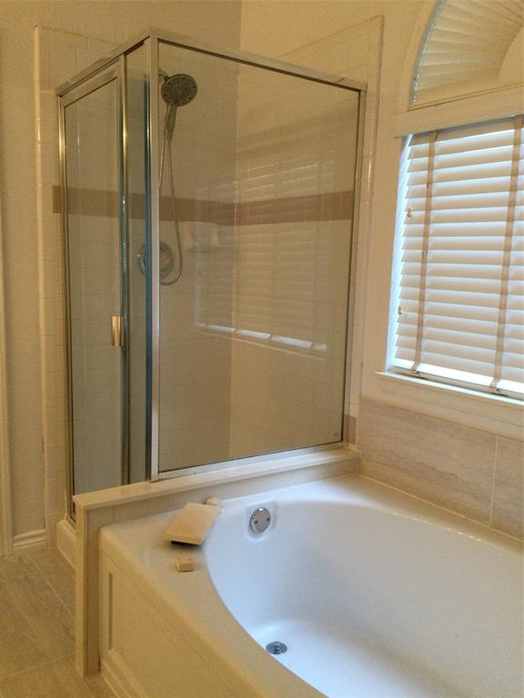 9814 Glenshee Drive Rowlett, TX 75089 - Photo 15 of 25 Full bathroom featuring a bath, a stall shower, and tile patterned floors