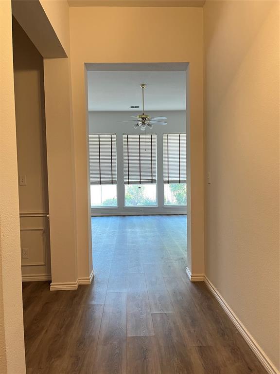 9814 Glenshee Drive Rowlett, TX 75089 - Photo 3 of 25 Corridor featuring dark wood-style floors and baseboards