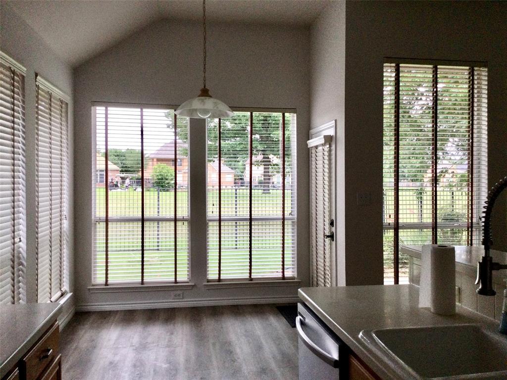 9814 Glenshee Drive Rowlett, TX 75089 - Photo 5 of 25 Dining space featuring dark wood finished floors and lofted ceiling