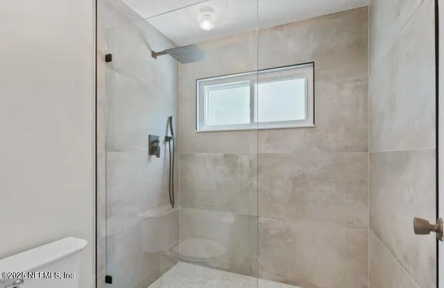a bathroom with a double vanity sink mirror and shower