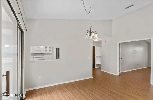 a large white kitchen with cabinets