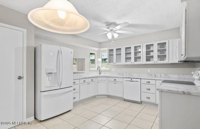 a kitchen with a sink dishwasher and cabinets
