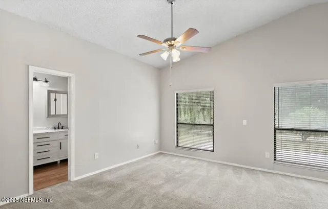 an empty room with chandelier fan