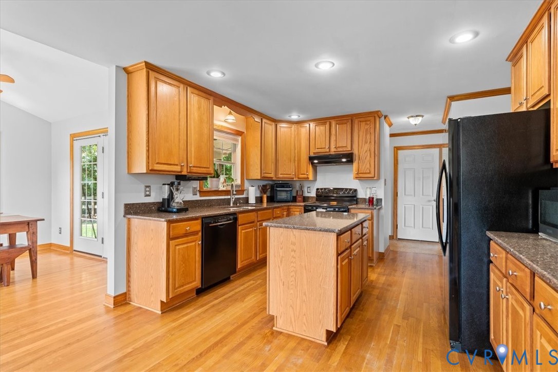 3137 Trenholm Road Powhatan, VA 23139 - Photo 18 of 72 a kitchen with stainless steel appliances granite countertop white cabinets a refrigerator a stove a sink and a microwave