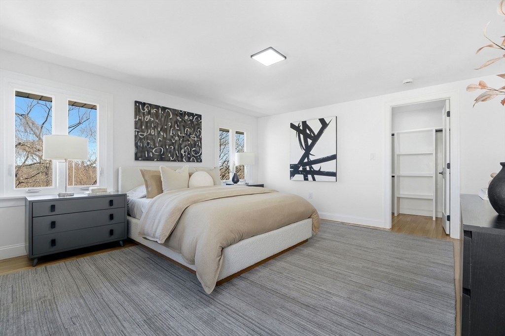 171 Shaw Road Brookline, MA 02467 - Photo 14 of 42 a spacious bedroom with a large bed and windows