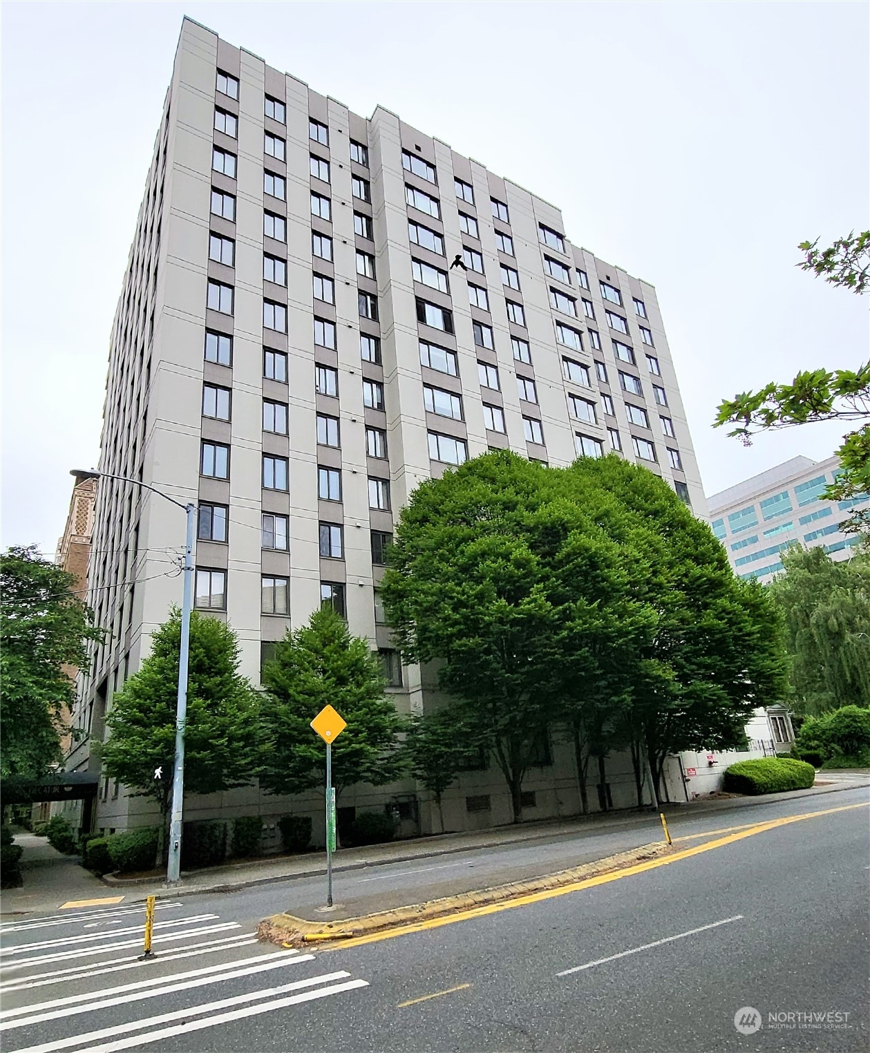 1105 Spring Street, Unit 607 Seattle, WA 98104 - Photo 4 of 18 a view of a tall building next to a road