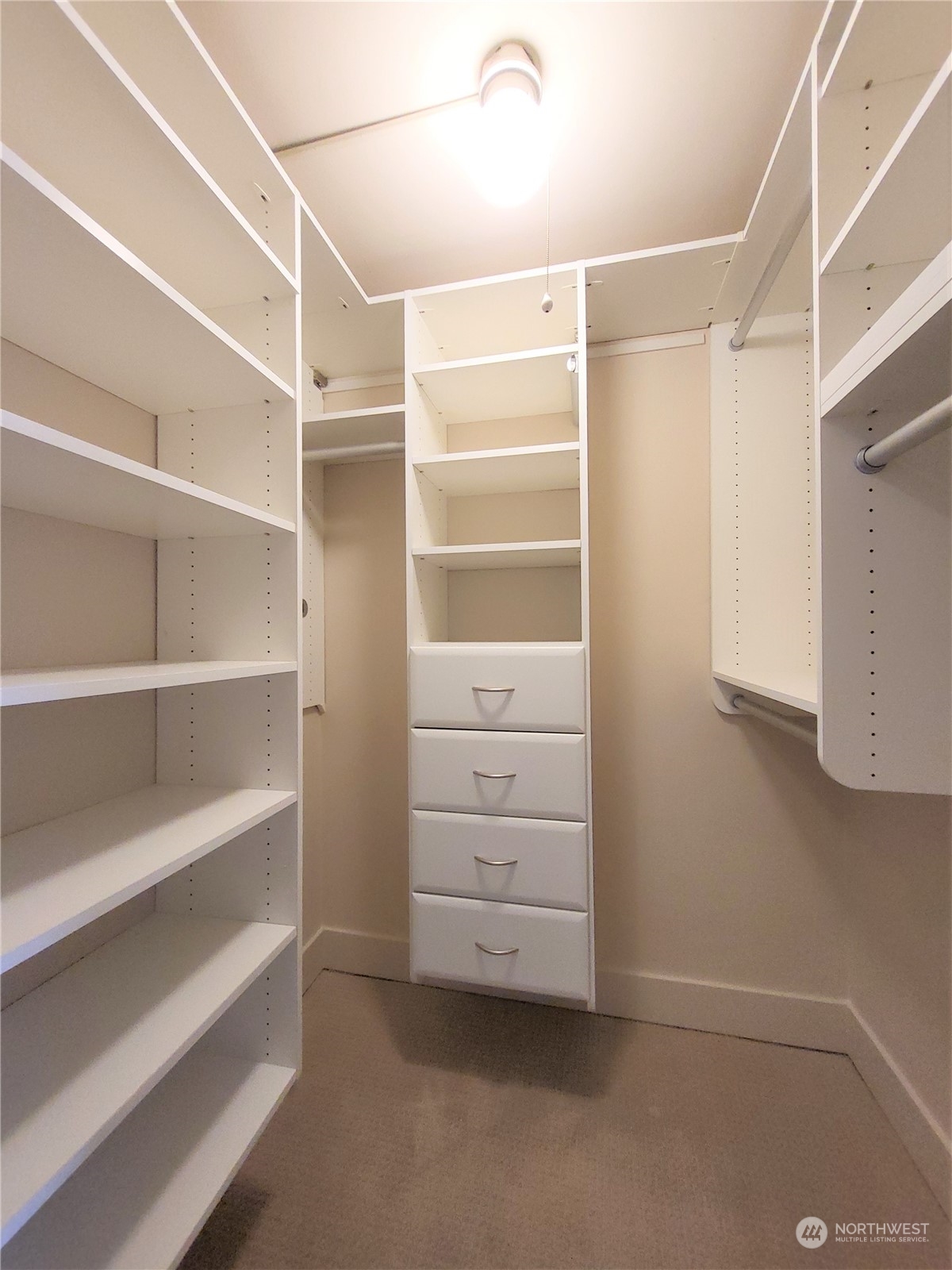 1105 Spring Street, Unit 607 Seattle, WA 98104 - Photo 8 of 18 a view of walk in closet with empty racks
