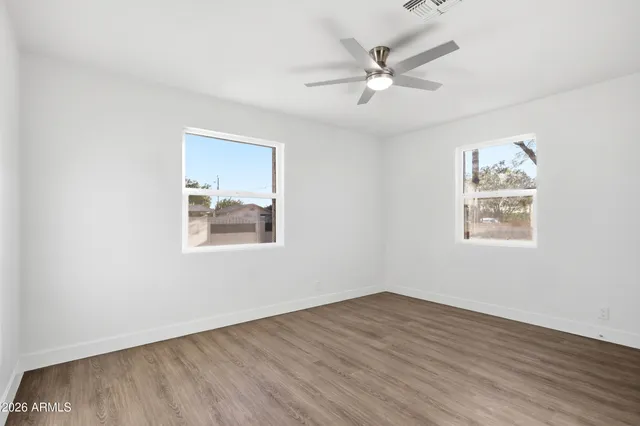 wooden floor in an empty room with a window
