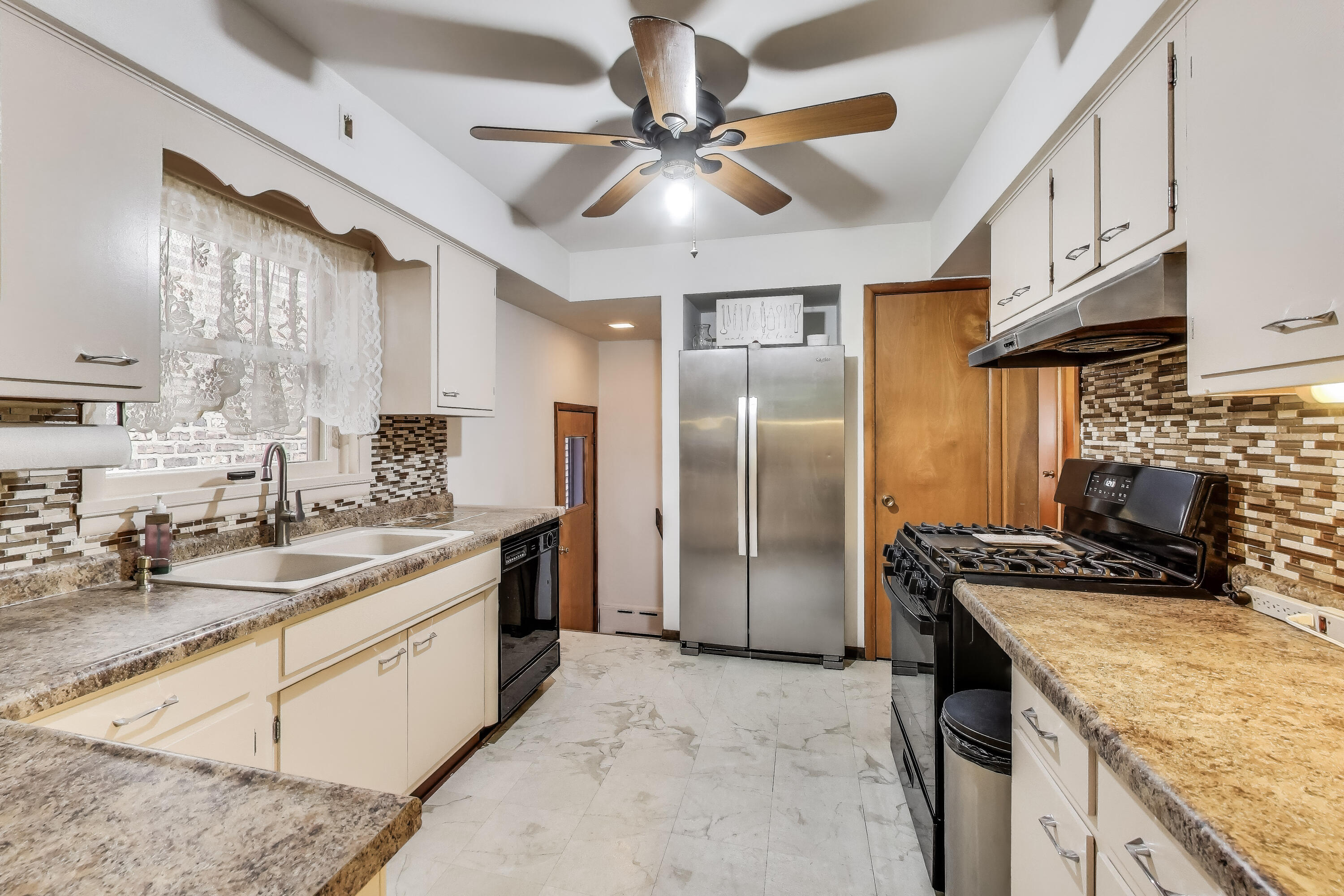 2036 Atchison Avenue Whiting, IN 46394 - Photo 7 of 30 a kitchen with stainless steel appliances granite countertop a sink a stove and a refrigerator