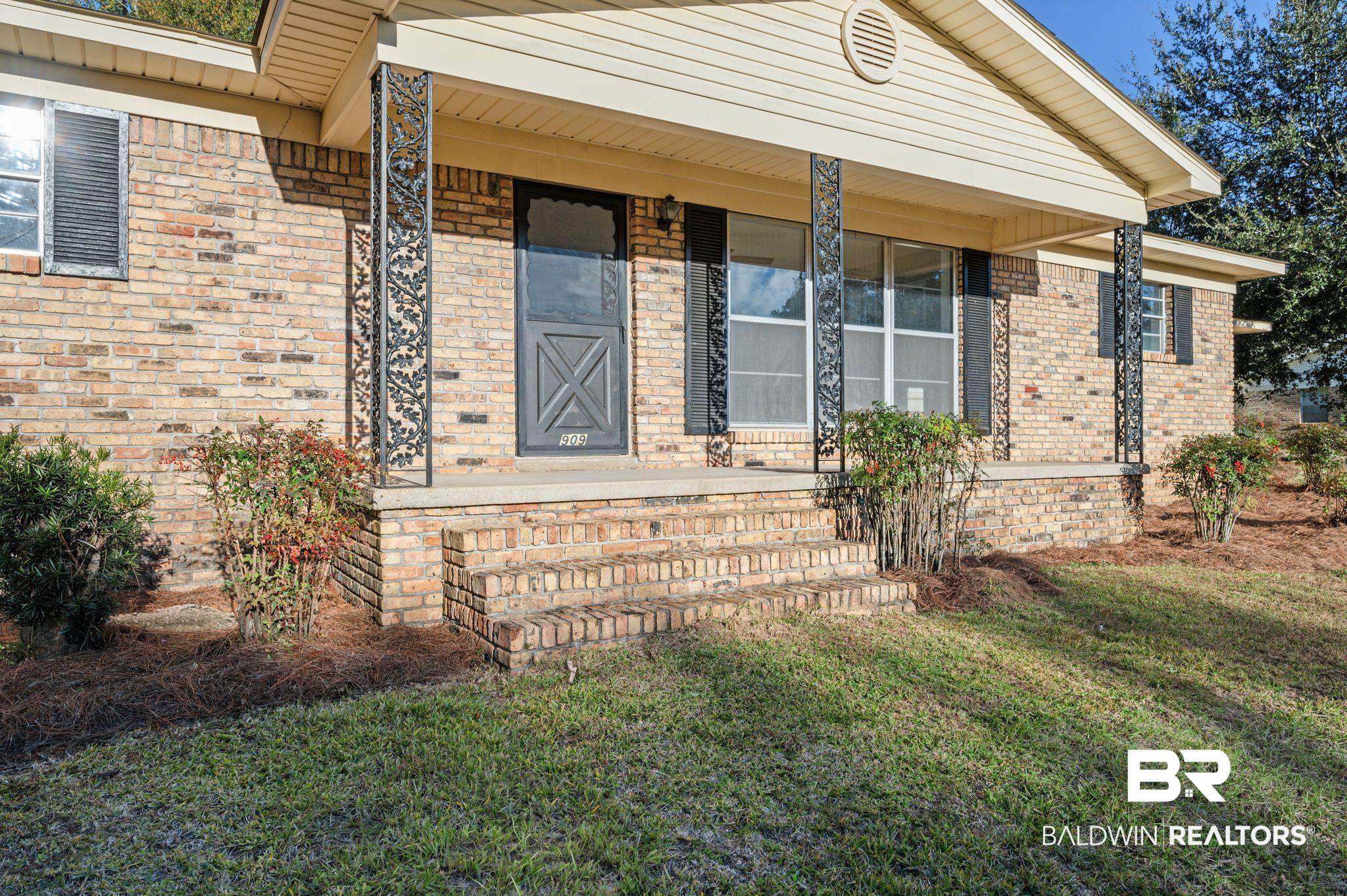 909 Caroline Avenue Daphne, AL 36526 - Photo 3 of 46 Entrance to property featuring a lawn and a porch
