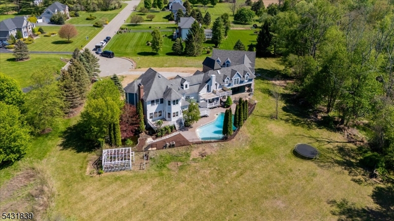 15 Spring Hunter Court Andover, NJ 07821 - Photo 46 of 49 an aerial view of a house with a yard and greenery