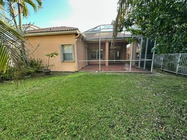 a view of a house with a yard and a garden