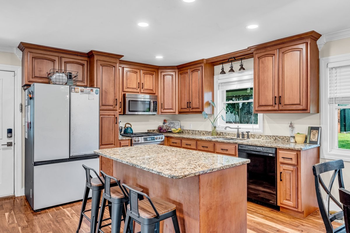 207 East Fort Street Tullahoma, TN 37388 - Photo 11 of 45 a kitchen with stainless steel appliances granite countertop a refrigerator a stove top oven a sink and dishwasher